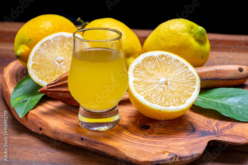 Ice cold sweet limoncello liqueur made from new harvest of fresh ripe yellow Italian lemons, Amalfi coast, Italy photo