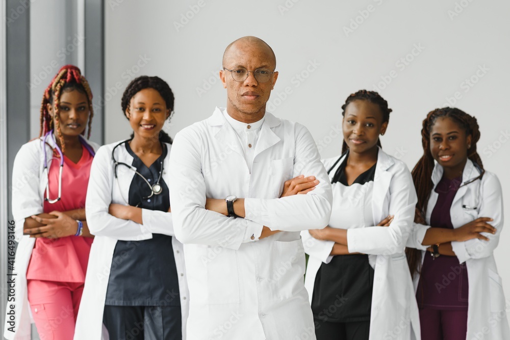 confident african medical doctor and colleagues portrait in hospital