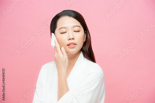 Face skin care. Smiling woman using facial oil blotting paper portrait.
