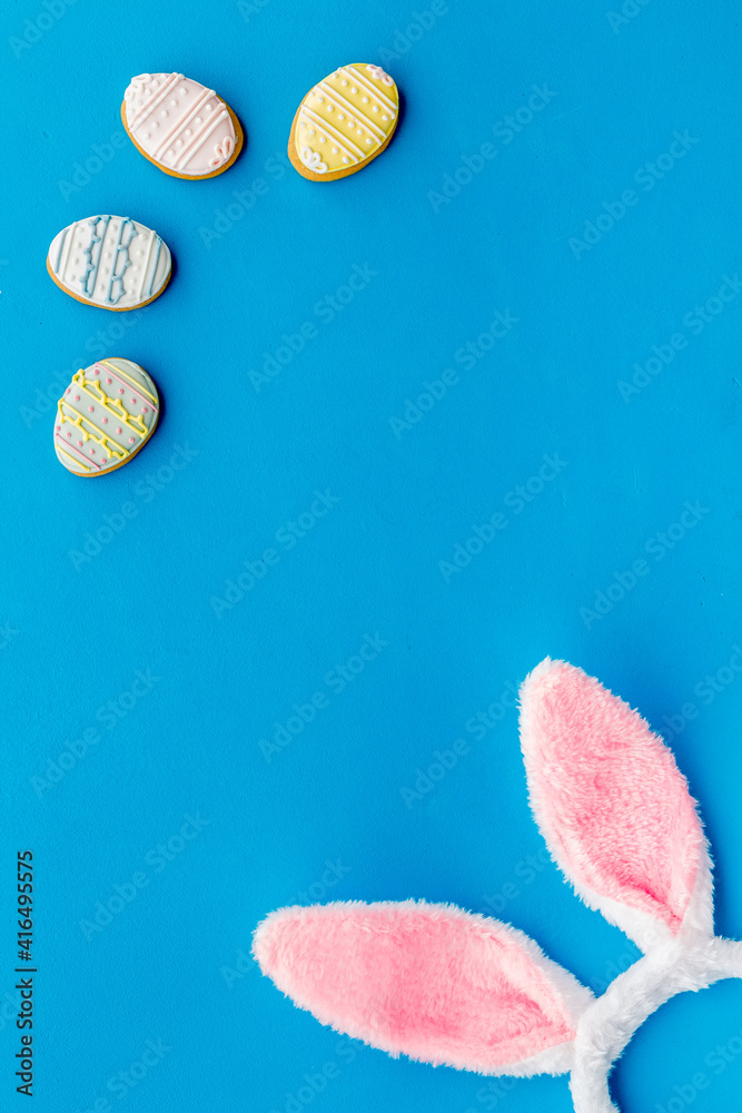 Happy Easter. Bunny ears with colorful eggs cookie, top view