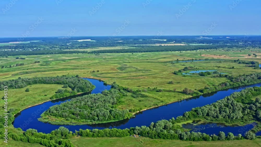Aerial cinematic: drone flies extremely high above a beautiful landscape with a meander river. Aerial view from drone flies over a green summer landscape. Top view of a wild nature. Spring. Meadows Aerial cinematic: drone flies extremely high above a beautiful landscape with a meander river. Aerial view from drone flies over a green summer landscape. Top view of a wild nature. Spring. Meadows