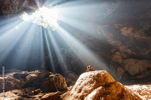 Fototapeta Sun Beams Shine Down Through Cave