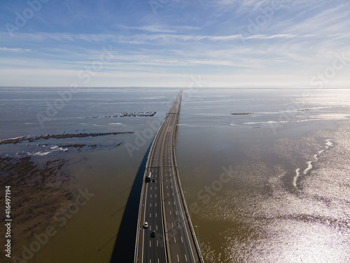 Aerial view of beautiful Vasco da Gama bridge's suspended highway road crossing the Tagus river, one of the world's longest bridge, Oriente district, Lisbon, Portugal. © Martina