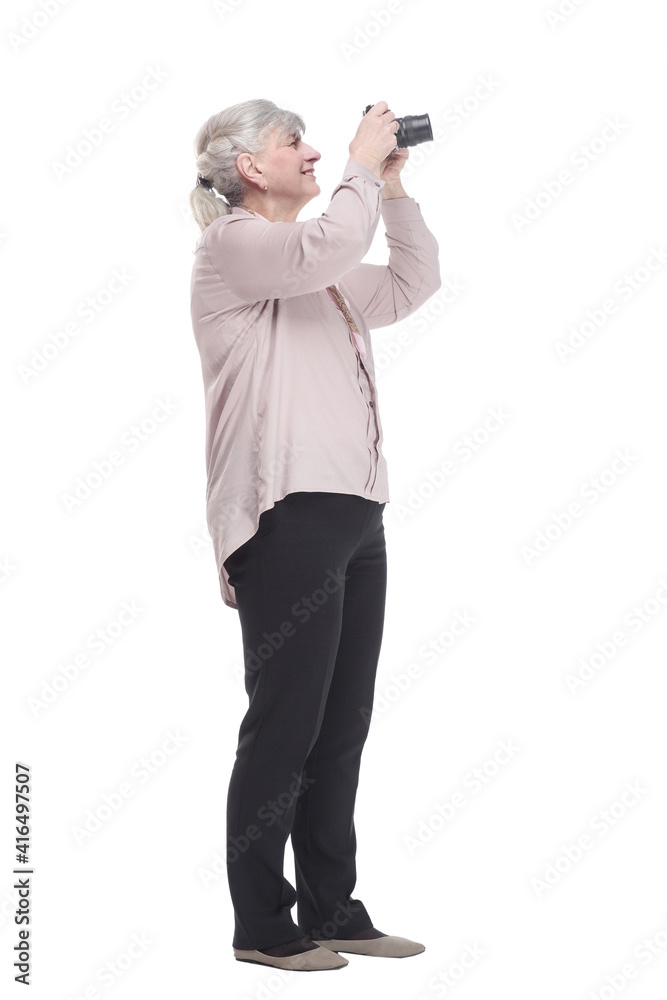 elderly lady tourist using a camera . isolated on a white background. elderly lady tourist using a camera . isolated on a white background.