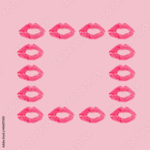 Creative frame made with red kisses on pastel pink background. Retro style aesthetic. 80s  90s Romantic aesthetic concept with kiss print and lipstick. Makeup idea. Valentines day idea.