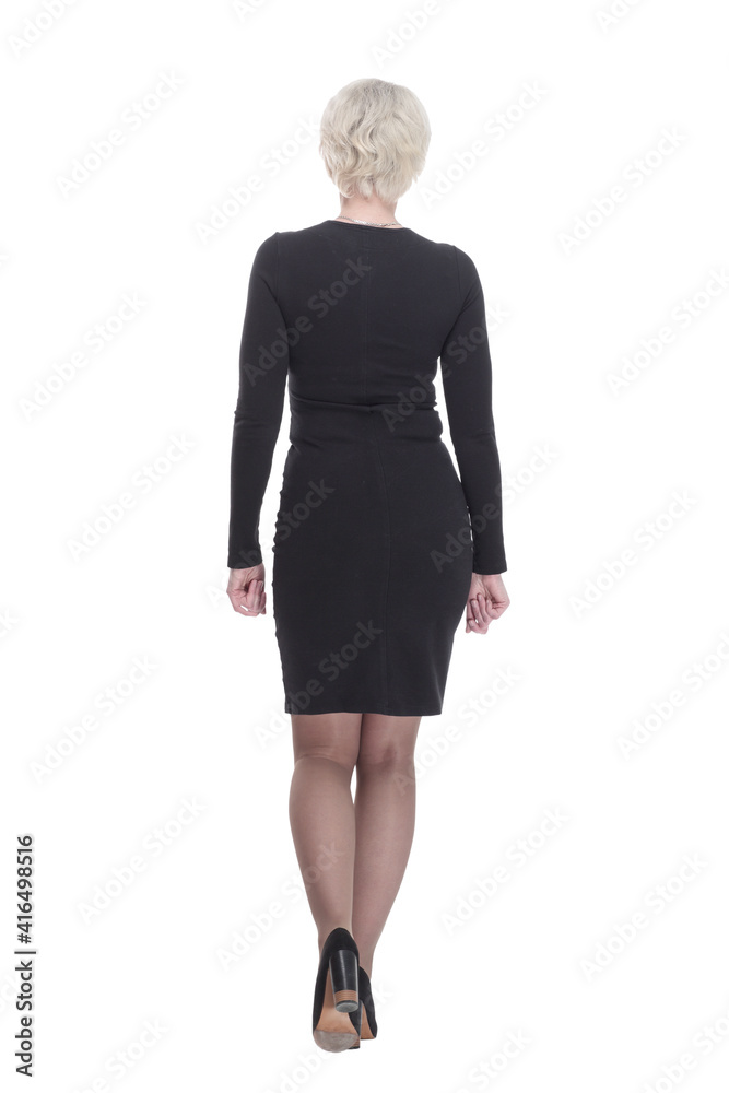 business woman in a black dress walking away. isolated on a white background. business woman in a black dress walking away. isolated on a white background.