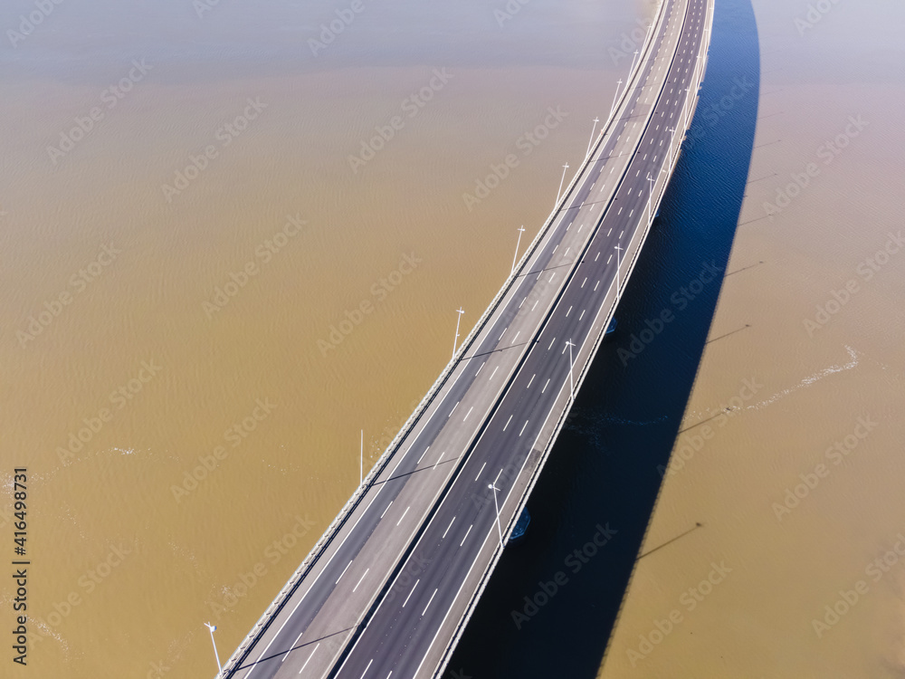 Fototapeta premium Aerial view of beautiful Vasco da Gama bridge's suspended highway road crossing the Tagus river, one of the world's longest bridge, Oriente district, Lisbon, Portugal.
