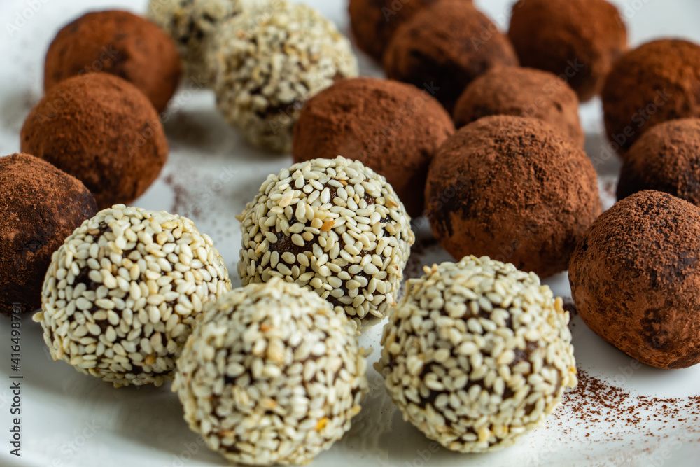 truffles with cocoa, coconut and sesame seeds with chocolate and marshmallows, delicious dessert on a white background truffles with cocoa, coconut and sesame seeds with chocolate and marshmallows, delicious dessert on a white background