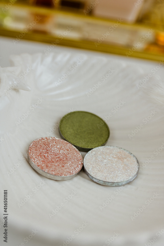 Round multicolored make up eyeshadows on white. Side view. Round multicolored make up eyeshadows on white. Side view.