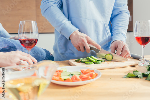 Close-up photo, hands cut vegetables into salad