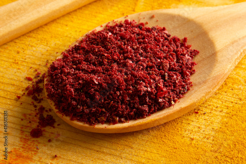 Fototapeta Naklejka Na Ścianę i Meble -  Healthy food concept. Sumac spice in the spoon.