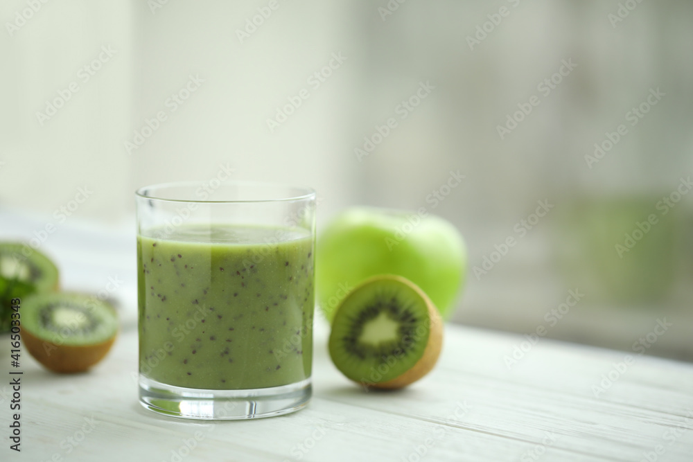 Delicious kiwi smoothie and fresh fruits on white wooden table. Space for text Delicious kiwi smoothie and fresh fruits on white wooden table. Space for text