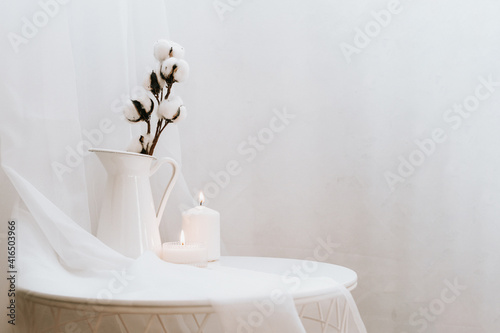 Details of still life in the home interior of living room on white background. Candle, vase. Moody. Copy space for text