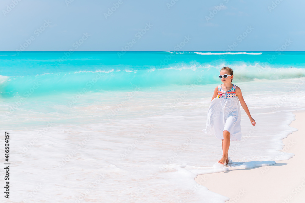Adorable little girl have fun at tropical beach during vacation Adorable little girl have fun at tropical beach during vacation