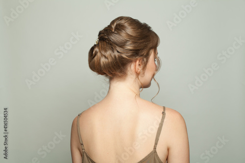 Beautiful female back with bridal hairdo, woman head and back on white background