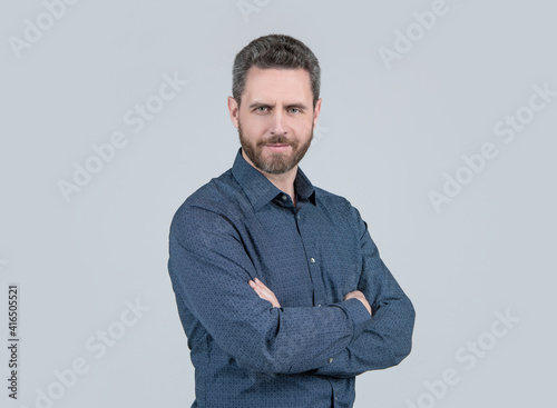 Bearded man in casual style shirt keep arms crossed feeling confidence grey background, comfortable