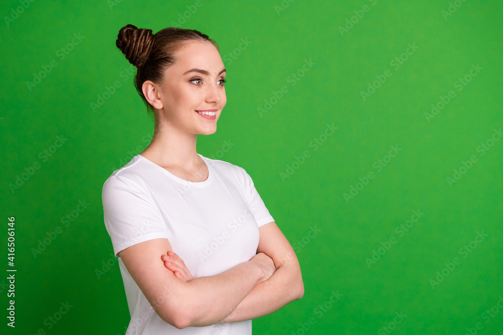 Profile side view portrait of attractive cheerful girl copy empty space folded arms isolated over bright green color background Profile side view portrait of attractive cheerful girl copy empty space folded arms isolated over bright green color background