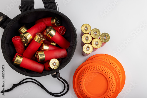 Clay disc flying targets and shotgun shells with bag on white background ,Clay Pigeon target photo