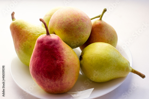 Fresh pears on the plate. White background