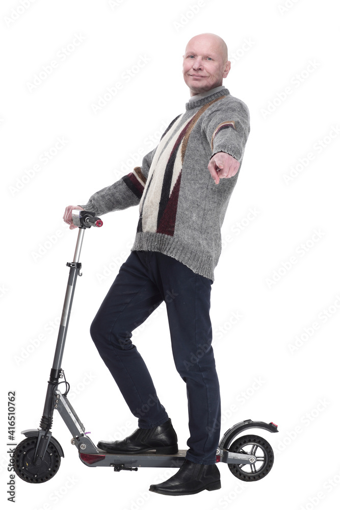 side view. mature man with electric scooter looking at you. side view. mature man with electric scooter looking at you.