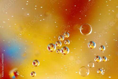 Świat bąbelków olejowych w wodzie na kolorowym tle w skali makro
