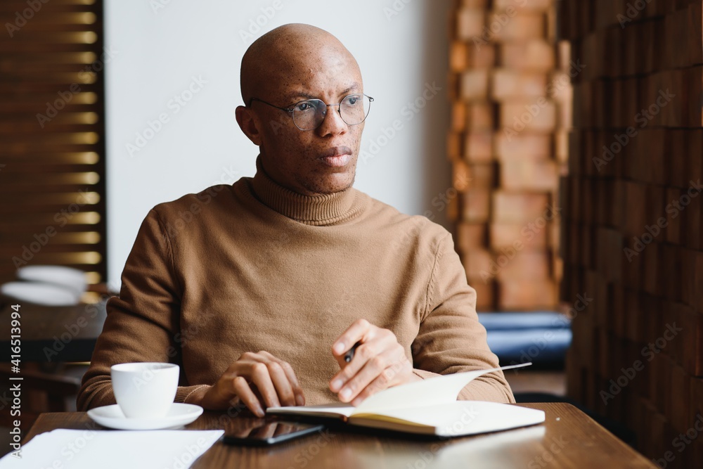 Planning The Day. Calm black student writing his lesson schedule in