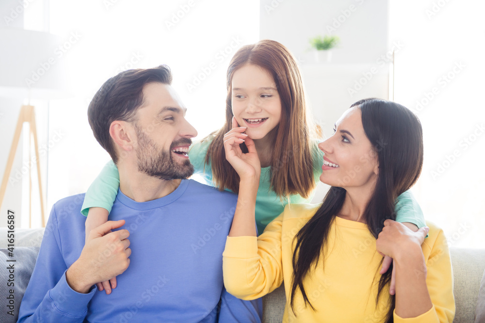 Photo of cheerful young family mom dad kid happy positive smile have fun enjoy time together weekend home Photo of cheerful young family mom dad kid happy positive smile have fun enjoy time together weekend home