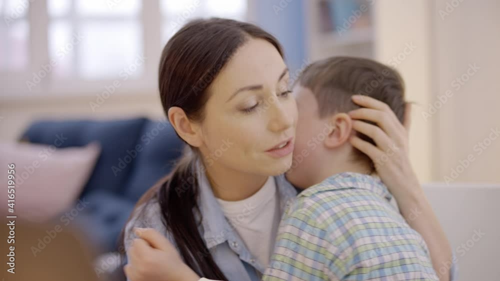 Young woman supporting crying child at home, family relationship, motherhood Young woman supporting crying child at home, family relationship, motherhood