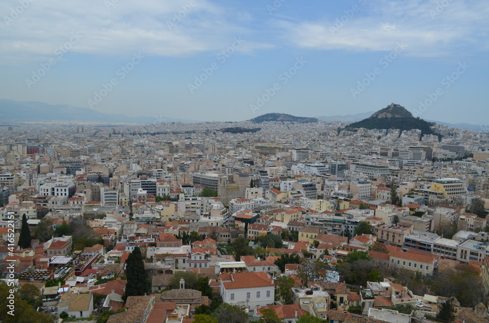 View of the cityscape of Athens with Mount Lycabettus in the distance from the Acropolis of Athens, Greece View of the cityscape of Athens with Mount Lycabettus in the distance from the Acropolis of Athens, Greece