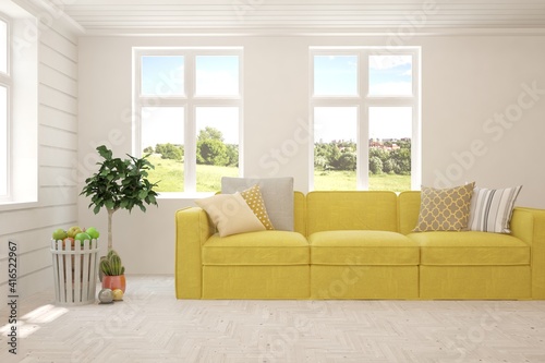 White living room with sofa and summer landscape in window. Scandinavian interior design. 3D illustration