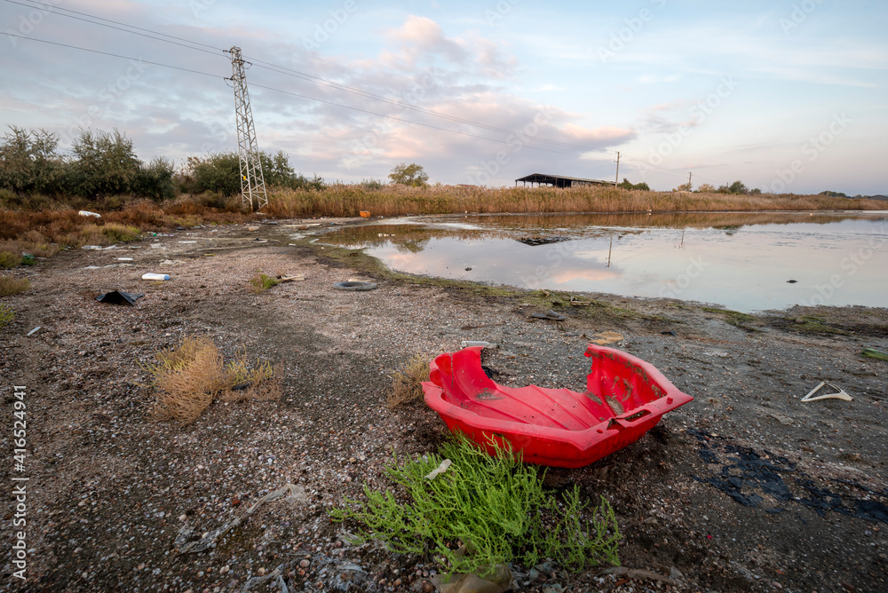 Pollution with household waste on Lake Pomorie near Burgas, Bulgaria. Imprint of human activity on nature. Pollution with household waste on Lake Pomorie near Burgas, Bulgaria. Imprint of human activity on nature.