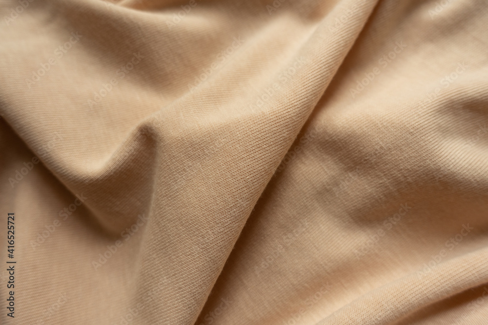 Fototapeta premium Light brown cotton jersey fabric in soft folds