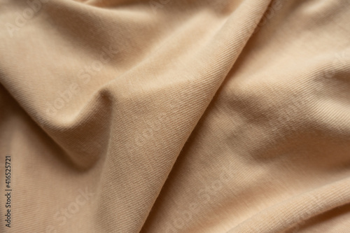 Light brown cotton jersey fabric in soft folds