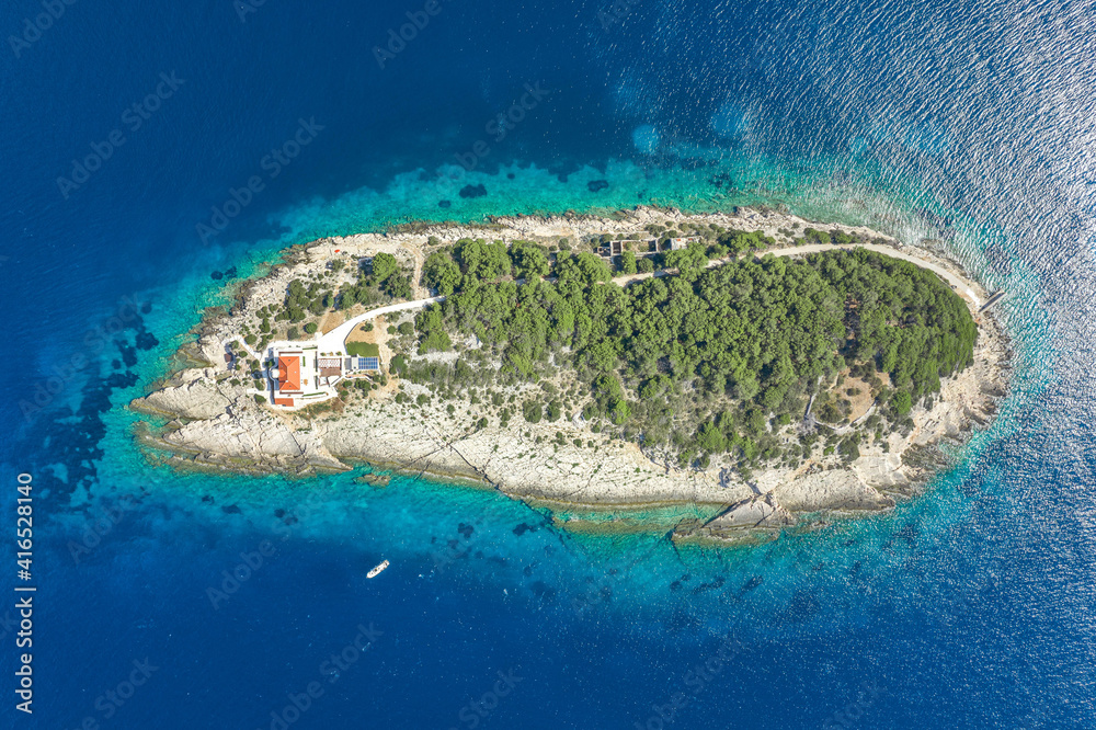 Aerial overhead drone shot of Host Island in Adriatic sea near Vis Island in Croatia summer