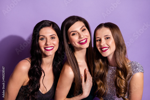 Photo of three classy fancy ladies beaming shiny smile wear elegant dresses isolated purple color background