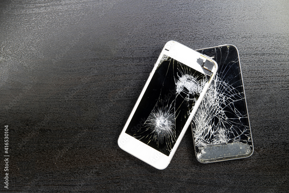 Screen cracked smartphone. Mobile phone with damaged touchscreen