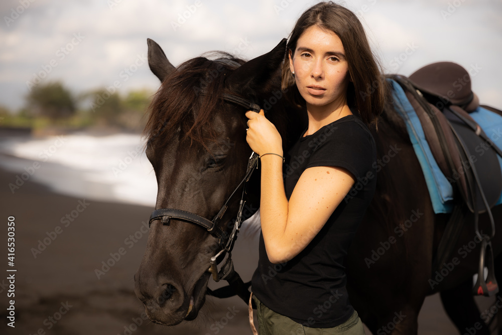 Portrait of charming woman and brown horse. Young Caucasian woman hugging horse. Romantic concept. Love to animals. Nature concept. Bali Portrait of charming woman and brown horse. Young Caucasian woman hugging horse. Romantic concept. Love to animals. Nature concept. Bali