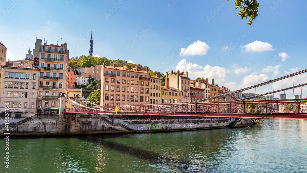 Fototapeta premium Old Lyon and Fourviere hill as seen from the Saint Vincent footbridge on a sunny day