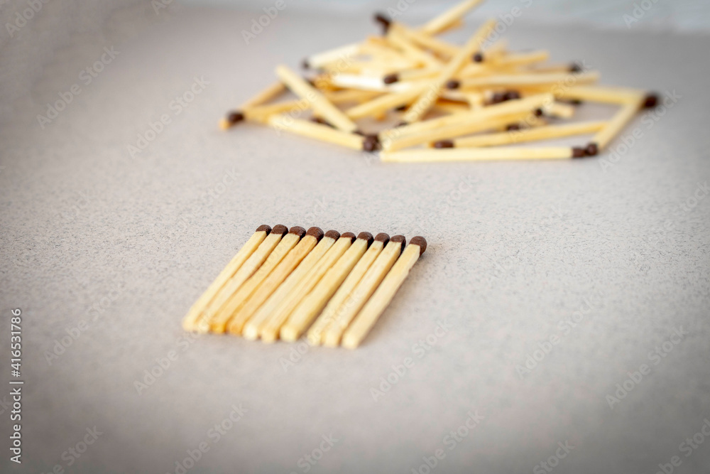 Lots of matches on a light background. The concept of chaos and order. Selective focus.