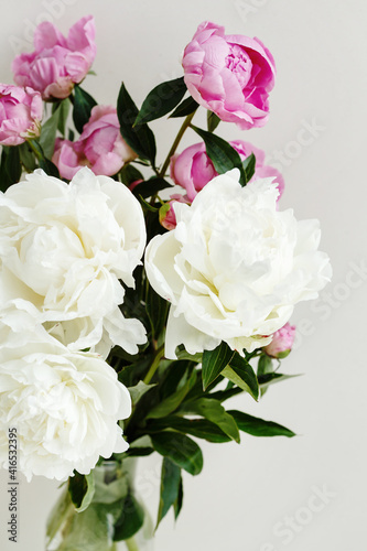 Simple sloopy flower bouquet of pink and white peonies flowers over pastel background © dariazu