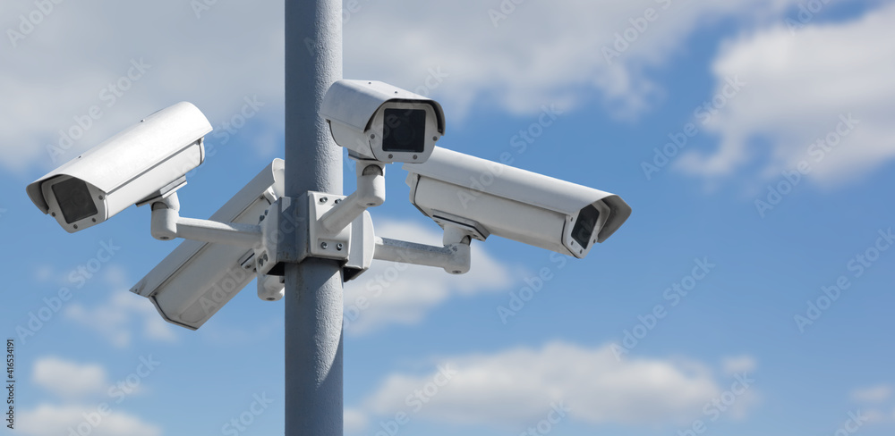 Four CCTV security cameras on a pole Four CCTV security cameras on a pole