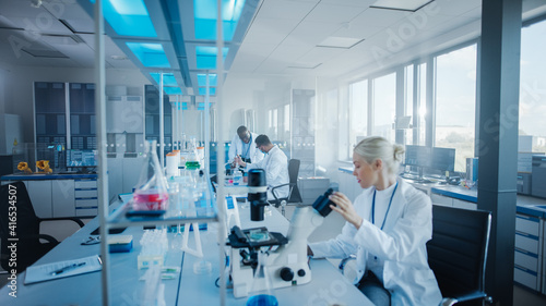 Modern Medical Research Laboratory  Team of Scientists Working with Pipette  Analysing Microbiological Sample  Talking. Advanced Scientific Lab for Drugs  Microbiology Development. High-Tech Equipment