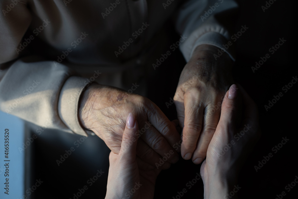 Fototapeta premium very elderly great-grandmother and granddaughter hold hands