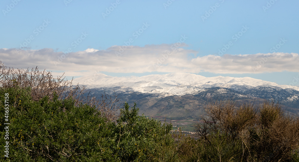 View  of the snow-capped peak of Mount Hermon and the valley under the mountain from the observation point of Mitzpe Benay in northern Israel