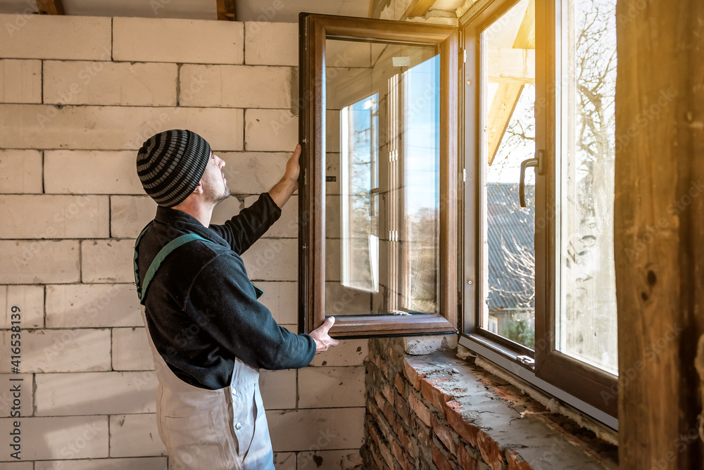 a professional worker inserts a new window a professional worker inserts a new window
