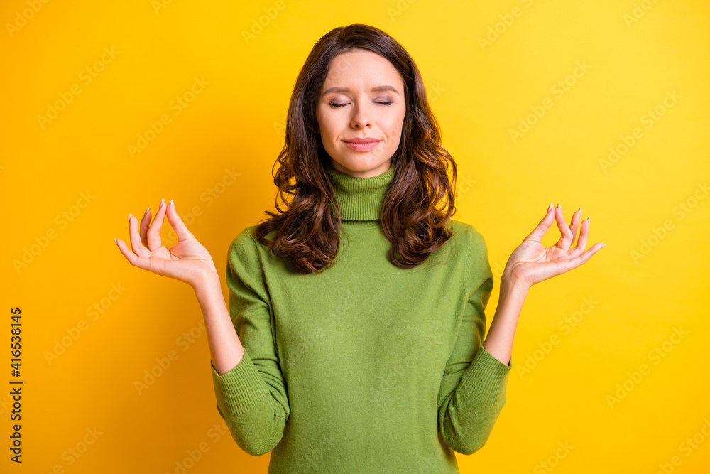 Photo of young beautiful calm happy smiling good mood woman doing yoga with closed eyes isolated on yellow color background