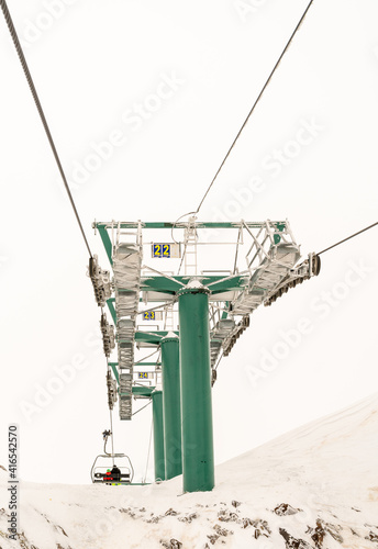 green structure of the telecavina in the ski center of the snowy mountain