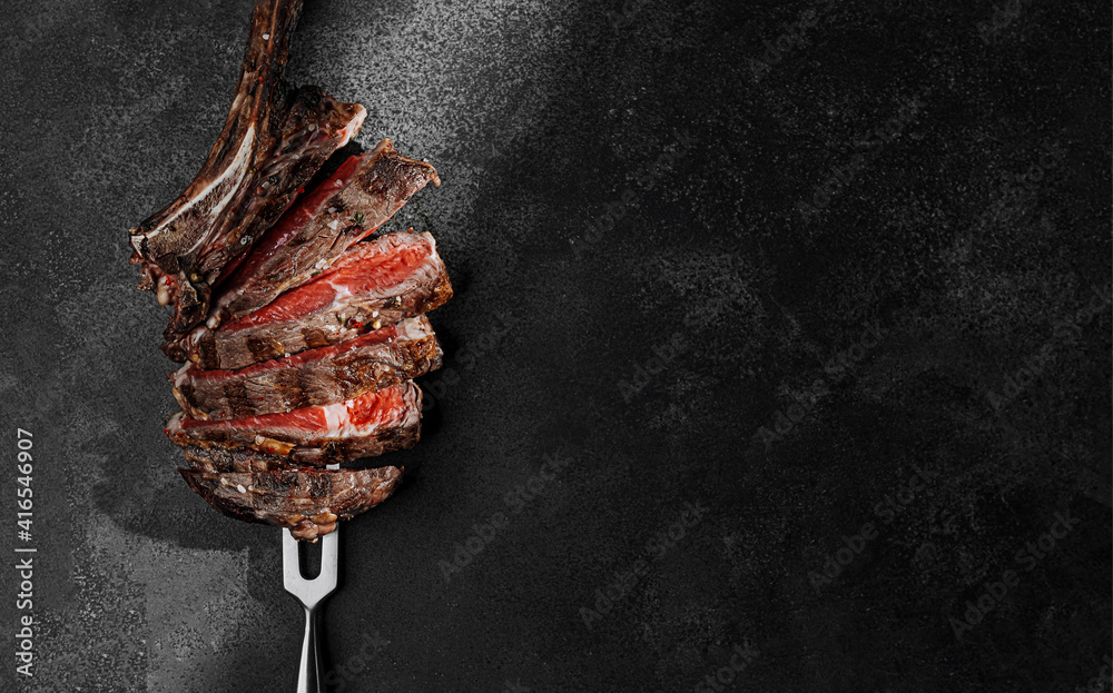 grilled beef steak on a dark background. expensive marbled beef of the highest grade fried to rare on the grill