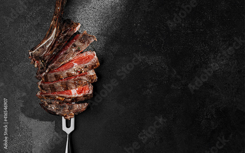 Obraz na płótnie grilled beef steak on a dark background. expensive marbled beef of the highest grade fried to rare on the grill w salonie