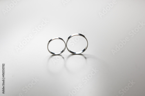 classic wedding rings made of white metal on a white background